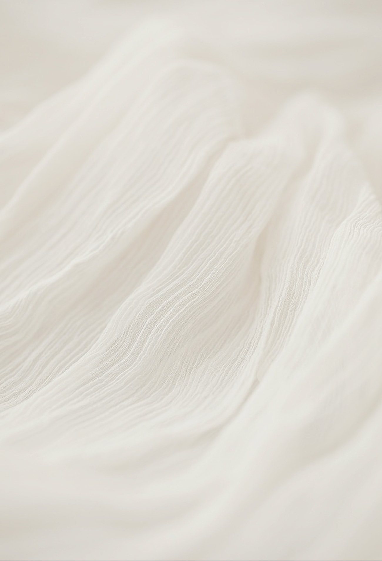 Textured white fabric with soft, flowing waves