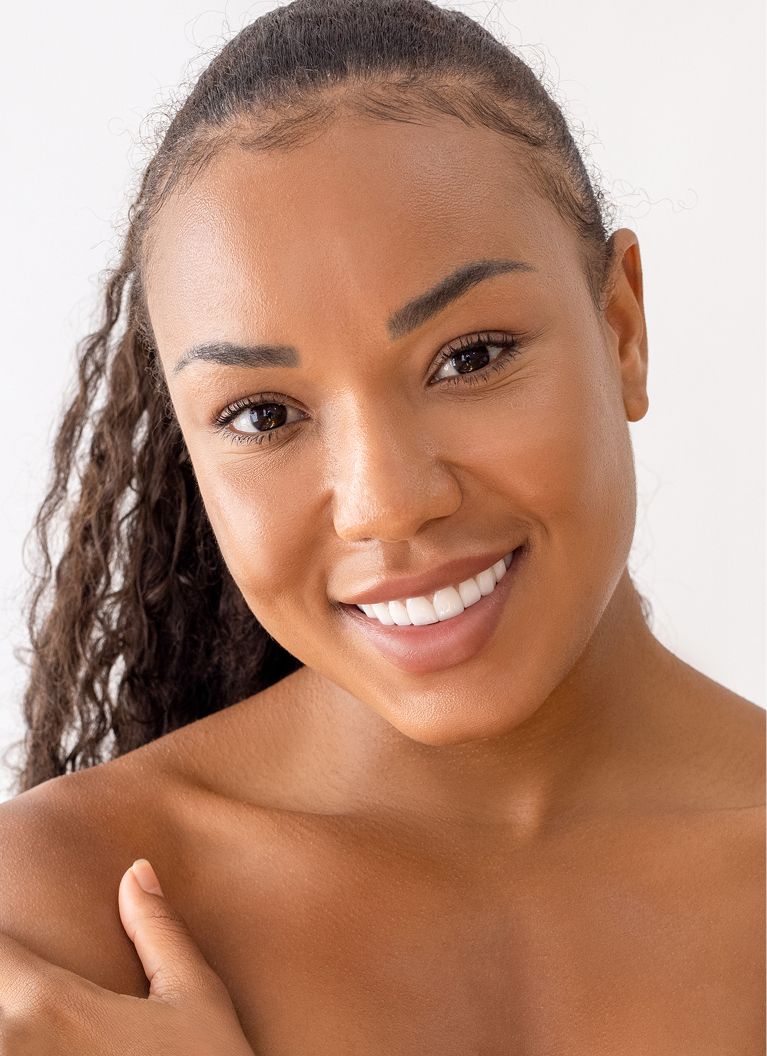 Woman with tousled hair and serene expression.