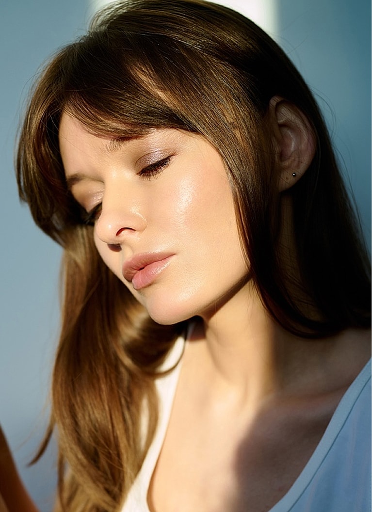 Close-up of a woman with soft lighting.