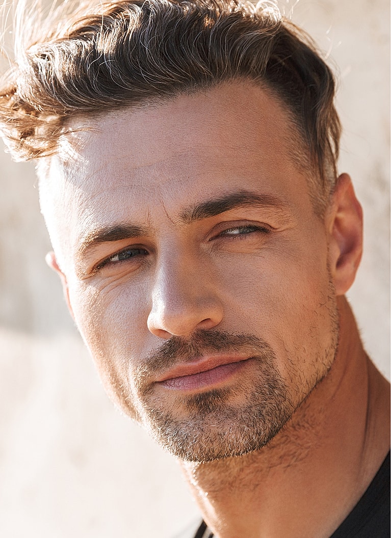 Man with stylish hair and confident expression.