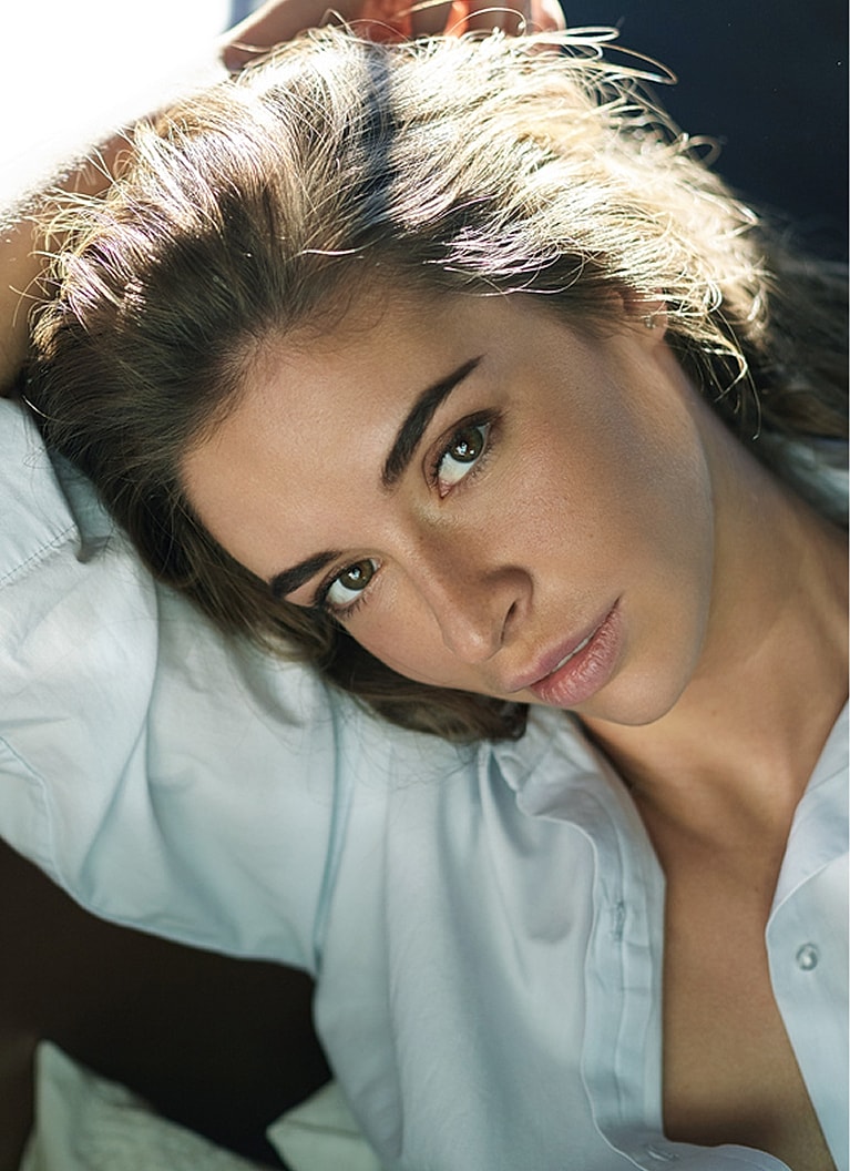 Person gazing thoughtfully with tousled hair.