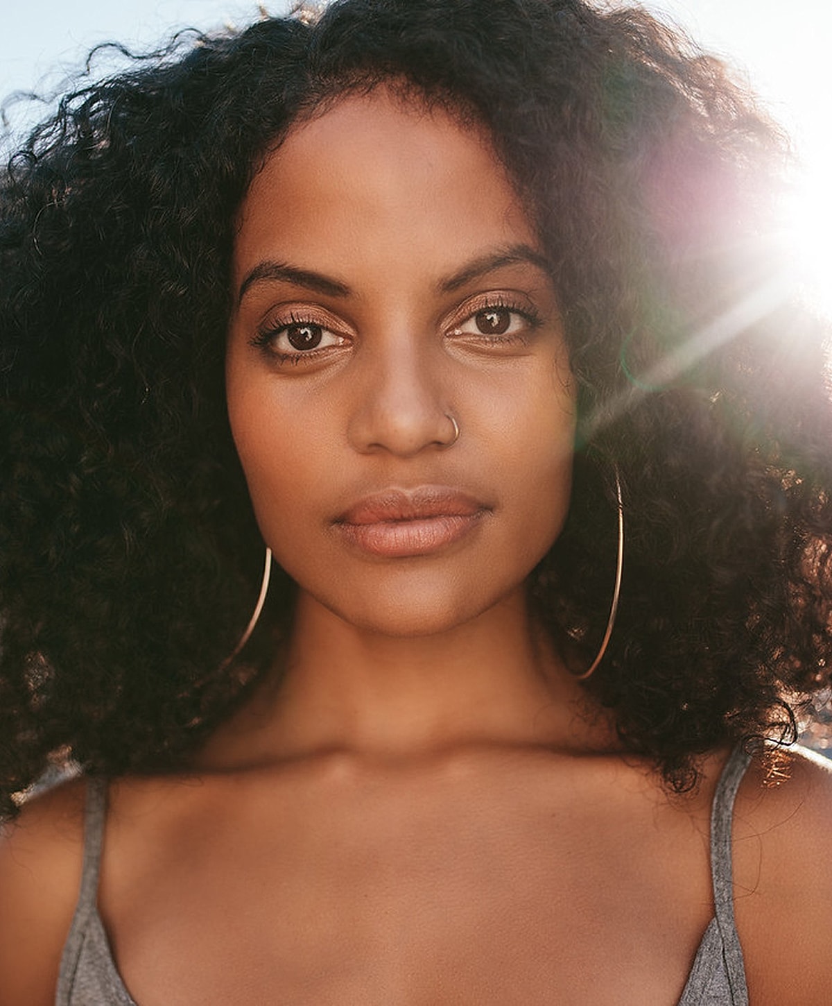 Portrait of a woman with curly hair.