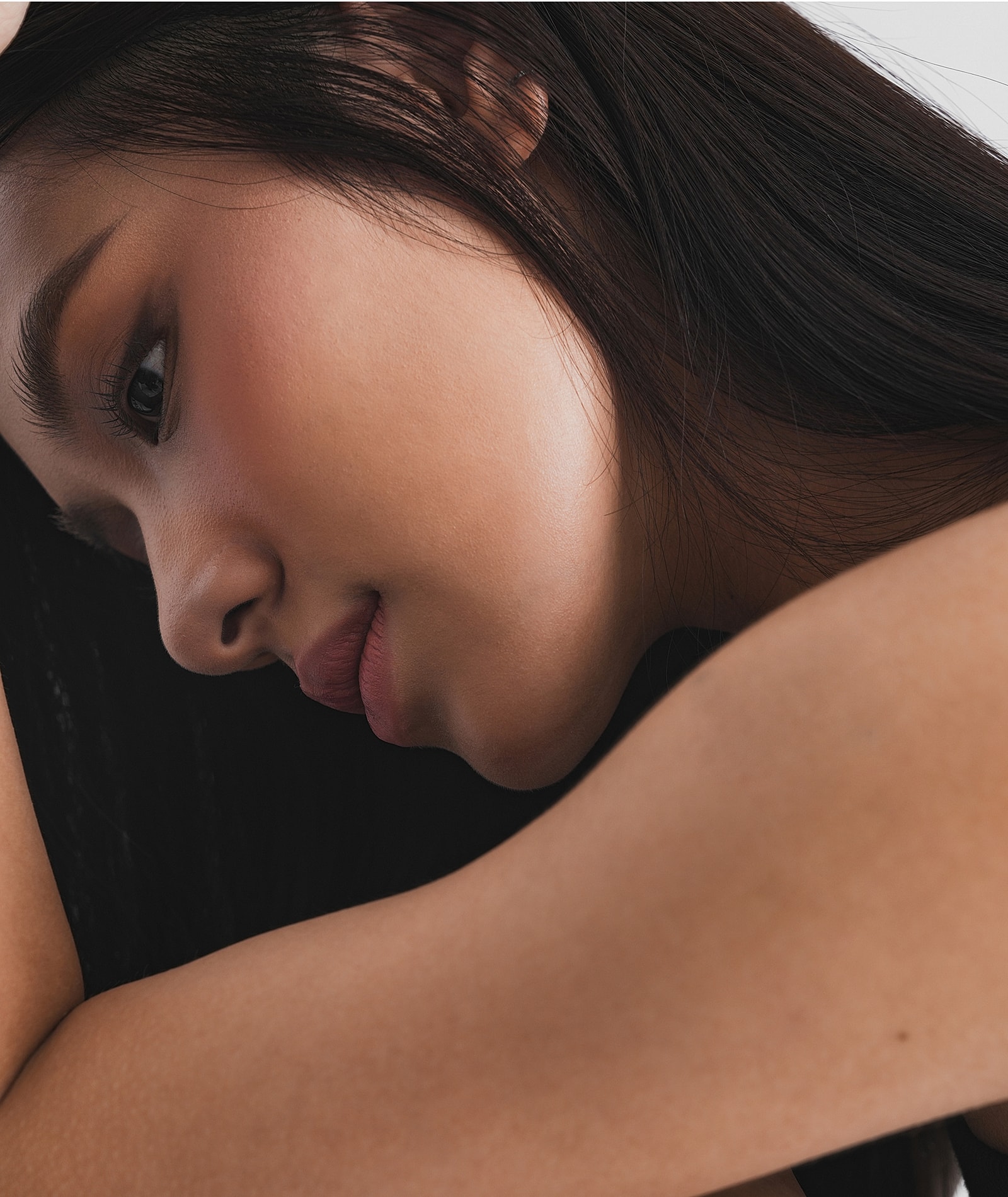 Side profile of a woman with soft expression.